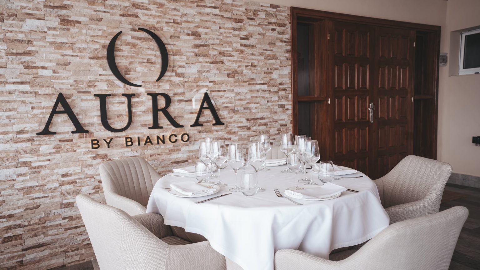 AURA by Bianco sign and a set round table